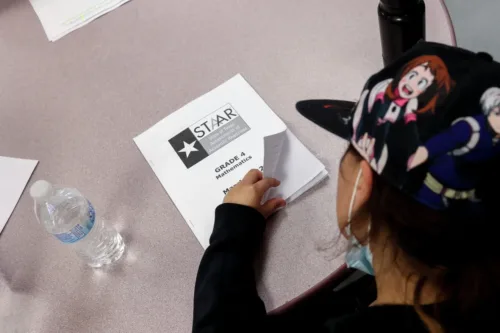 A fourth grader flips open her STAAR mathematics booklet to go over her answers during class at Heritage Elementary School in San Antonio, Texas, on March 3, 20222. Superintendent Ramirez visited the school as part of his ongoing teacher assessments and mock testing evaluations. Josie Norris/San Antonio Express-News